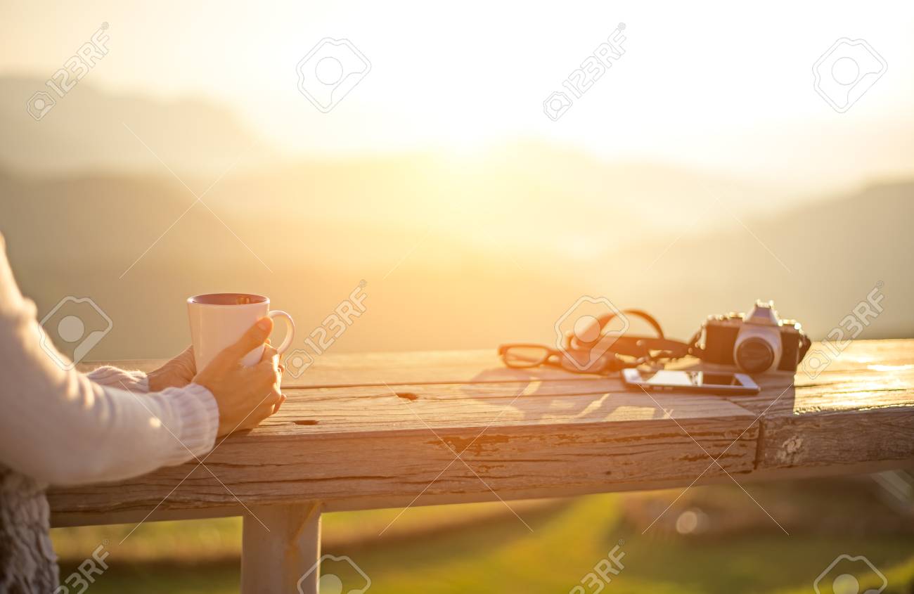 Woman Drinking Coffee In Sun Sitting Outdoor In Sunshine Light ...