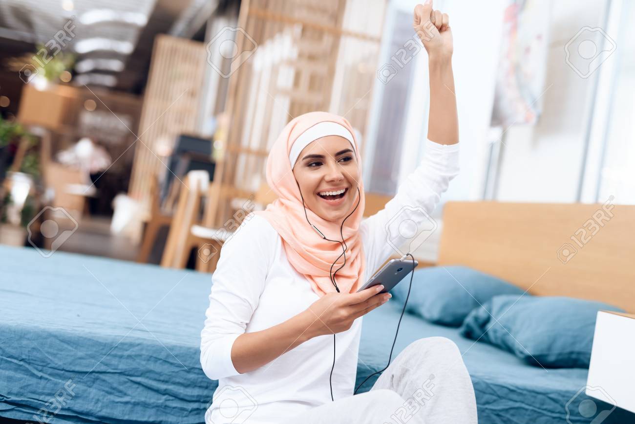 Arab Woman In Hijab Rest After Gymnastics She Listens To Music On Her Mobile Phone She S At Home Stock Photo Picture And Royalty Free Image Image 97589718