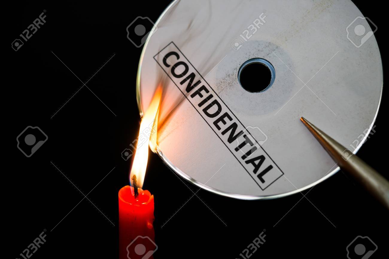 burning a confidential compact disc with candle in dark stock photo compact disc burning