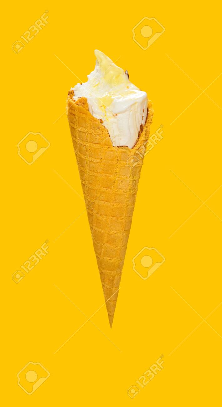 Side View Half Eaten Vanilla Flaovr Ice Cream Cone On A Yellow Stock Photo Picture And Royalty Free Image Image