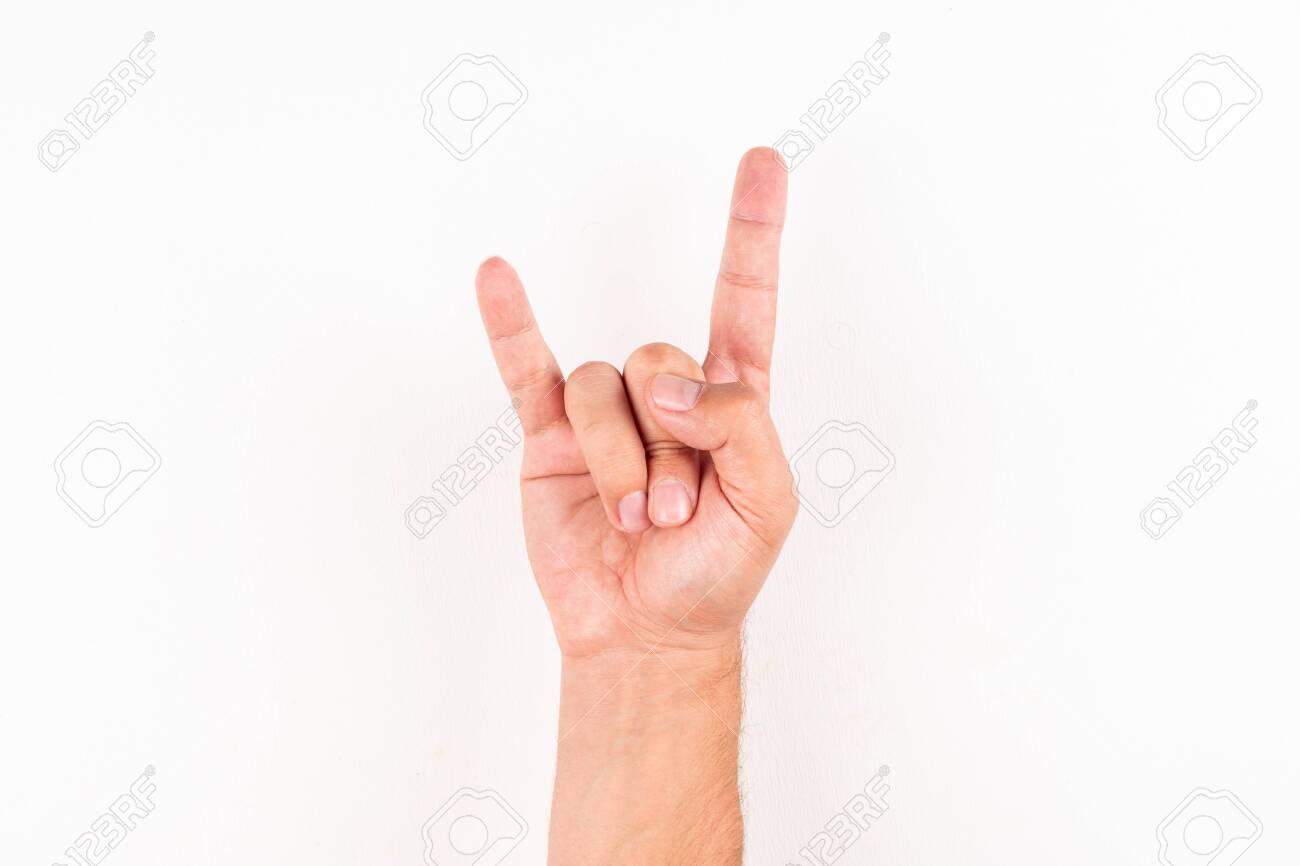 Man showing rock n roll hand sign gesture top view on a white background - 143690950 Man showing rock n roll hand sign gesture top view on a white background - 143690950