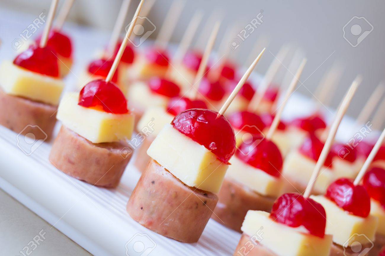 Appetizers with cherry, cheese and salami skewed on a toothpick placed in a tray - 17311912 Appetizers with cherry, cheese and salami skewed on a toothpick placed in a tray - 17311912