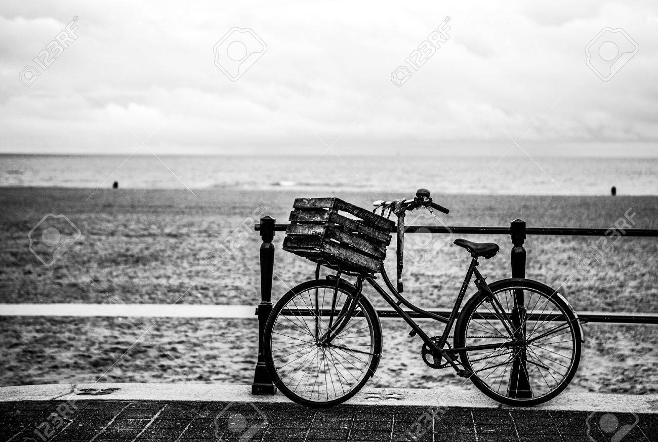 old style bicycle with basket on coast of the north sea in the