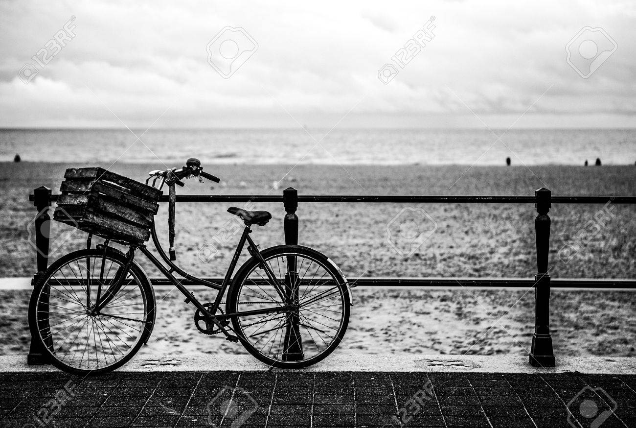 old style bicycle with basket on coast of the north sea in the