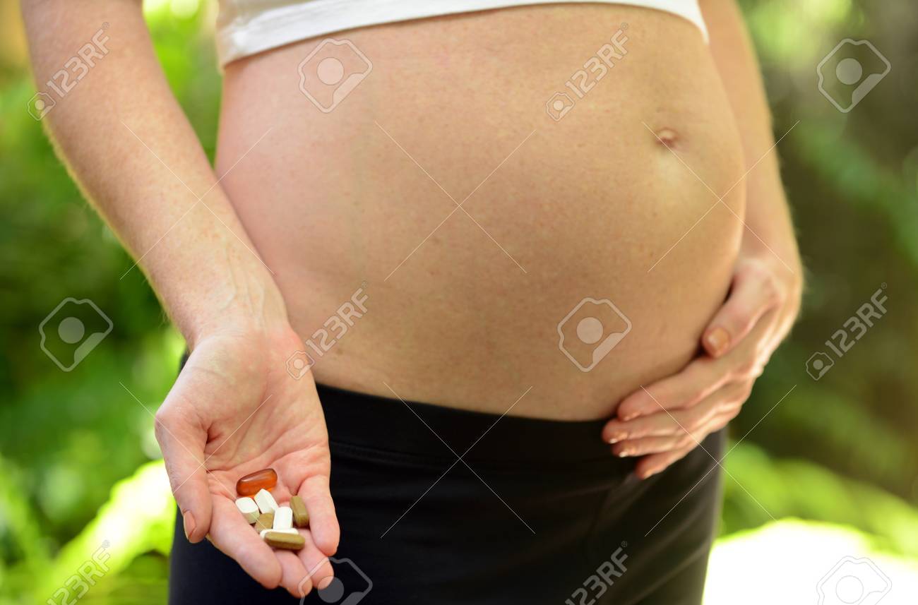 Pregnant Woman Taking Prenatal Vitamins Fish Oil And Supplements Stock Photo Picture And Royalty Free Image Image 20860587
