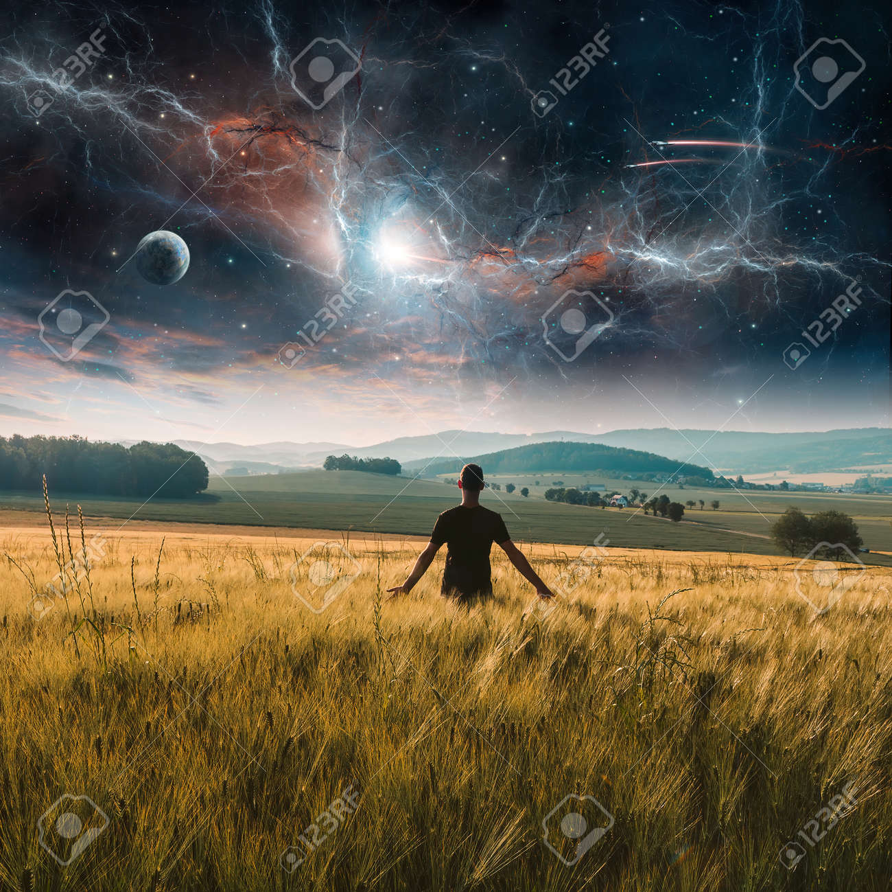 Young Man Standing In Rural Czech Wheat Field Landscape With Planet,  Fractal Nebula, Stars And Cloud At Sunset. Fantasy Photo Manipulation.  Elements Furnished , 3D Rendering Stock Photo, Picture and Royalty Free