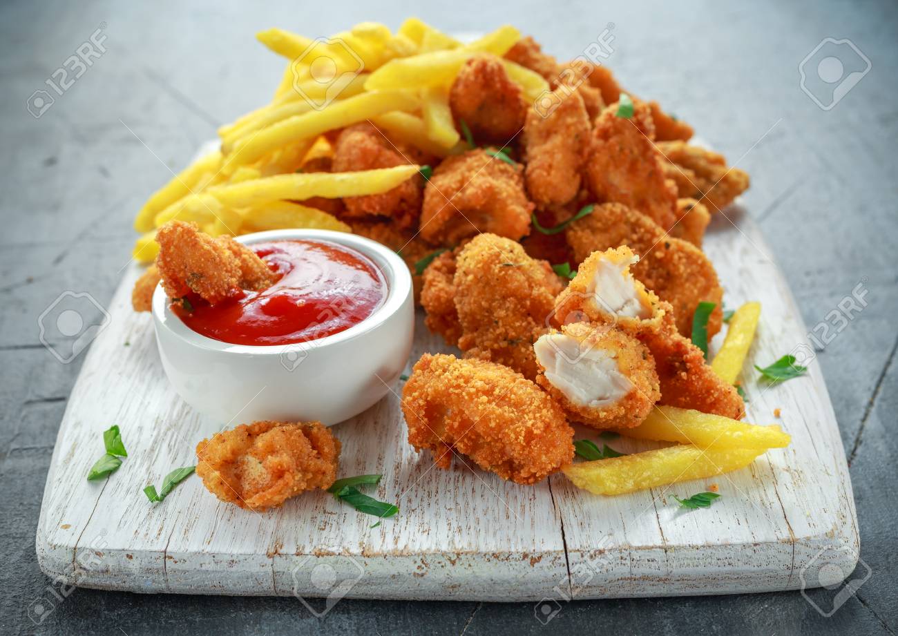 Fried crispy chicken nuggets with french fries and ketchup on white board - 80026048 Fried crispy chicken nuggets with french fries and ketchup on white board - 80026048