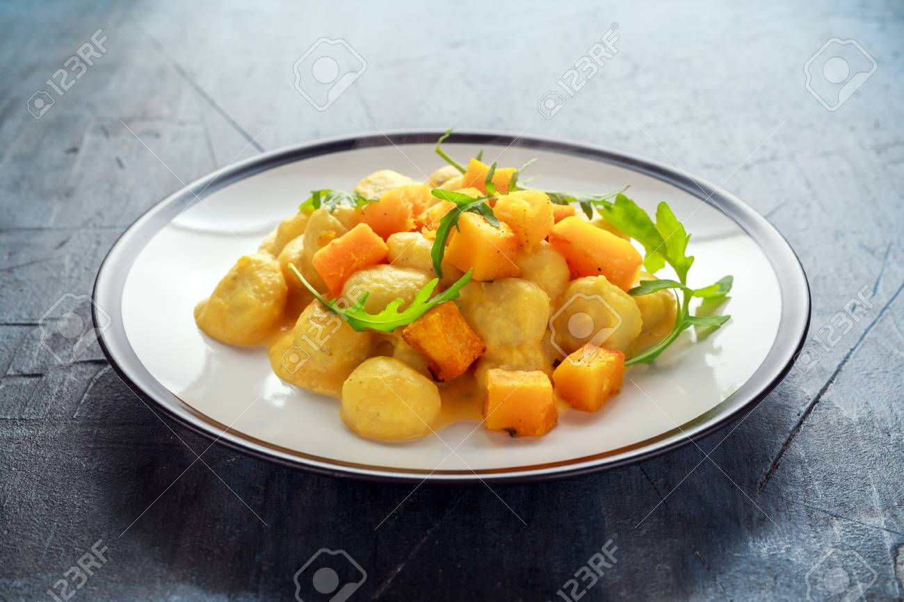 Homemade Butternut squash gnocchi with wild rocket in a plate - 87328268 Homemade Butternut squash gnocchi with wild rocket in a plate - 87328268