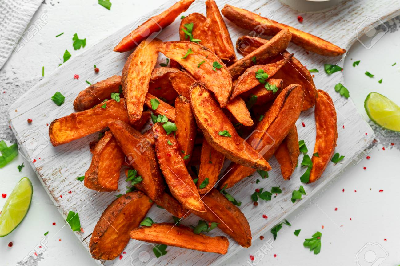 Healthy Homemade Baked Orange Sweet Potato wedges with fresh cream dip sauce, herbs, salt and pepper. - 91197251 Healthy Homemade Baked Orange Sweet Potato wedges with fresh cream dip sauce, herbs, salt and pepper. - 91197251