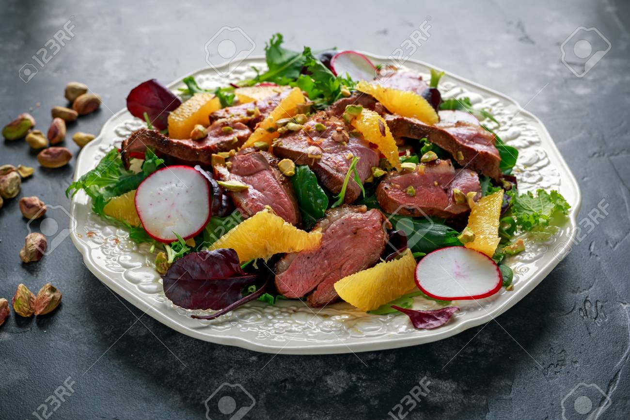 Duck fillets steak salad with orange halves, radishes and crushed pistachios - 96459681 Duck fillets steak salad with orange halves, radishes and crushed pistachios - 96459681