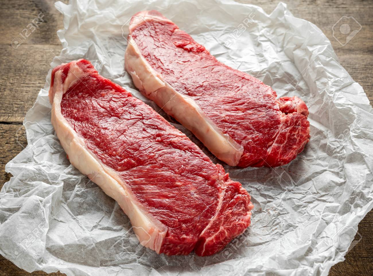 Raw premium beef sirloin steak on cooking paper - 98234955 Raw premium beef sirloin steak on cooking paper - 98234955
