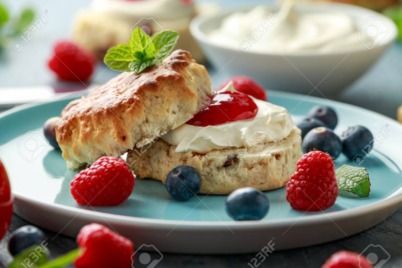 Classic English scones with clotted cream, strawberries jam and other fruit - 123050497 Classic English scones with clotted cream, strawberries jam and other fruit - 123050497