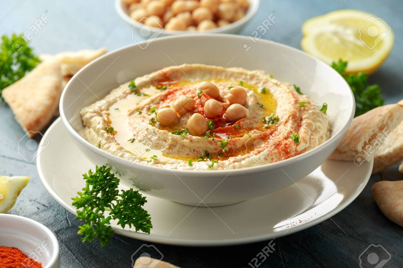 Hummus with olive oil, paprika, lemon and pita bread - 123674925 Hummus with olive oil, paprika, lemon and pita bread - 123674925