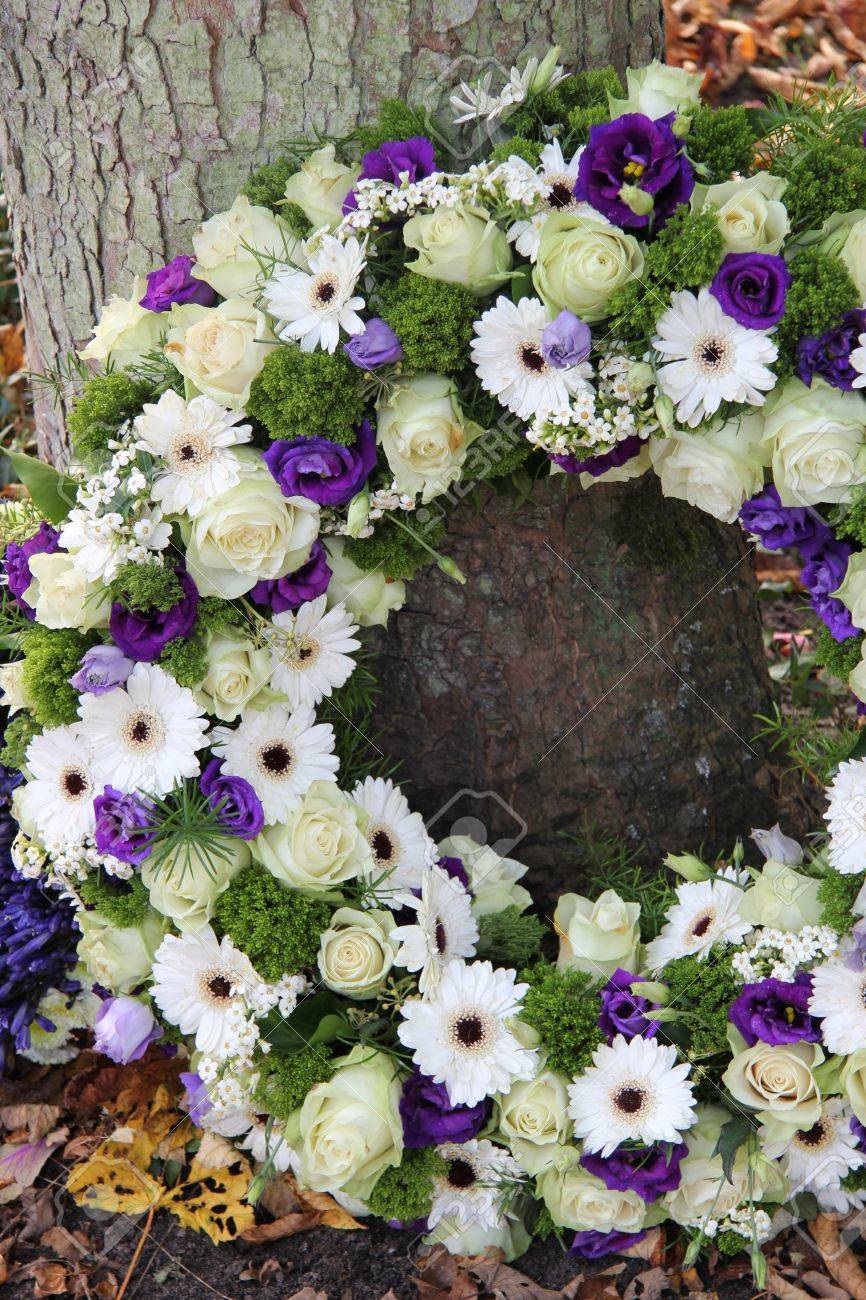 White and purple sympathy flowers in a funeral wreath - 16331185 White and purple sympathy flowers in a funeral wreath - 16331185