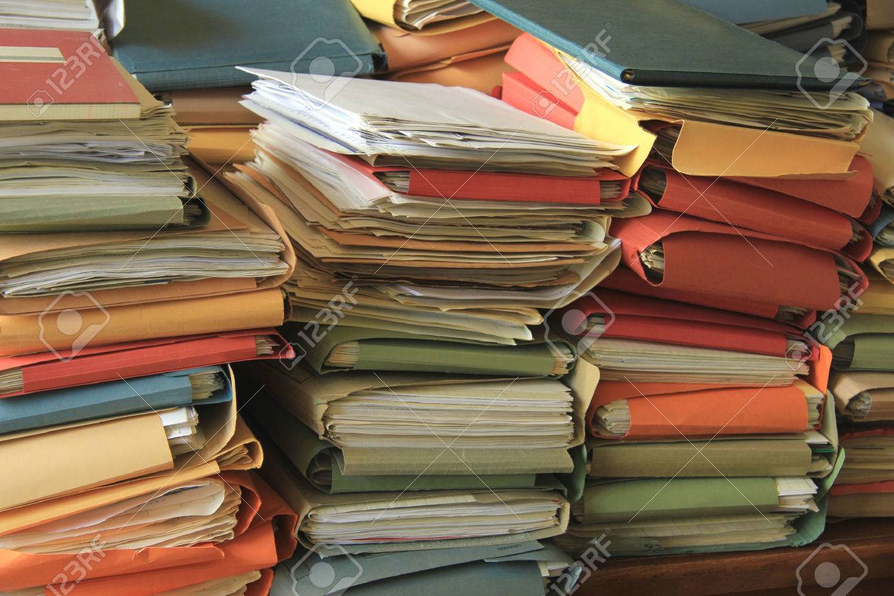 Stacked office files: pile of paperwork in an office - 30448479 Stacked office files: pile of paperwork in an office - 30448479