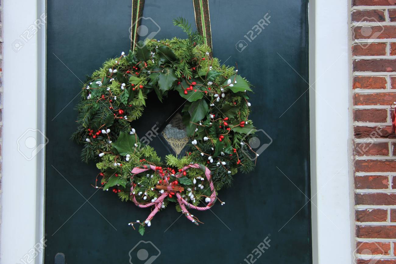 Classic christmas wreath with decorations on a door - 38608129 Classic christmas wreath with decorations on a door - 38608129