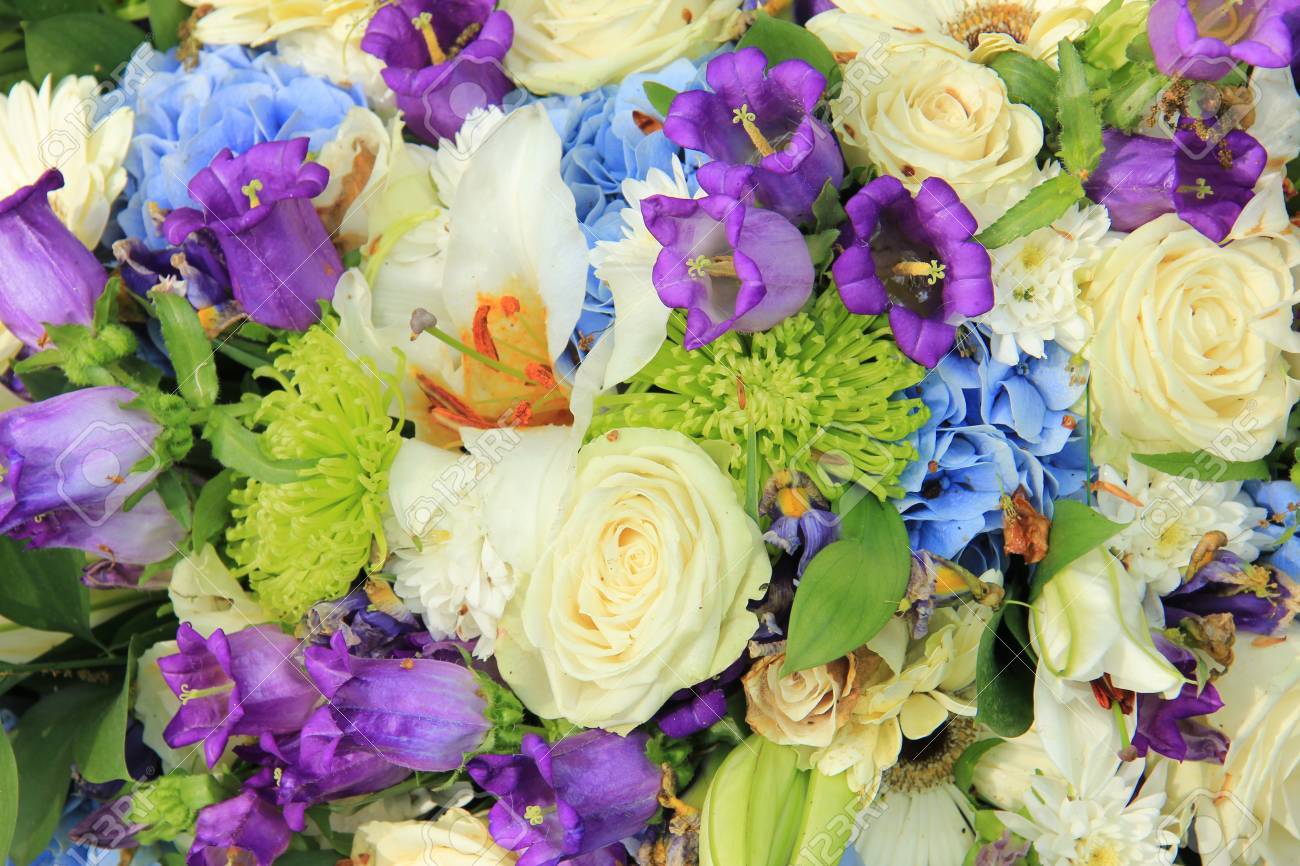 stock photo white roses and blue purple flowers in a wedding flower arrangement