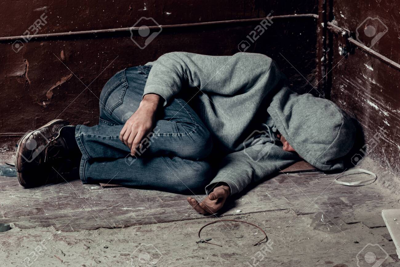 homeless guy sleeps on the floor in the slums. - 126139408 homeless guy sleeps on the floor in the slums. - 126139408