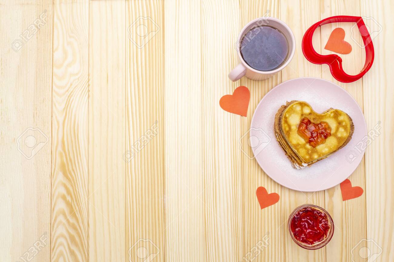 Heart shaped pancakes for romantic breakfast with strawberry jam and black tea. Shrovetide (carnival) concept. On wooden background, top view. - 136827906 Heart shaped pancakes for romantic breakfast with strawberry jam and black tea. Shrovetide (carnival) concept. On wooden background, top view. - 136827906