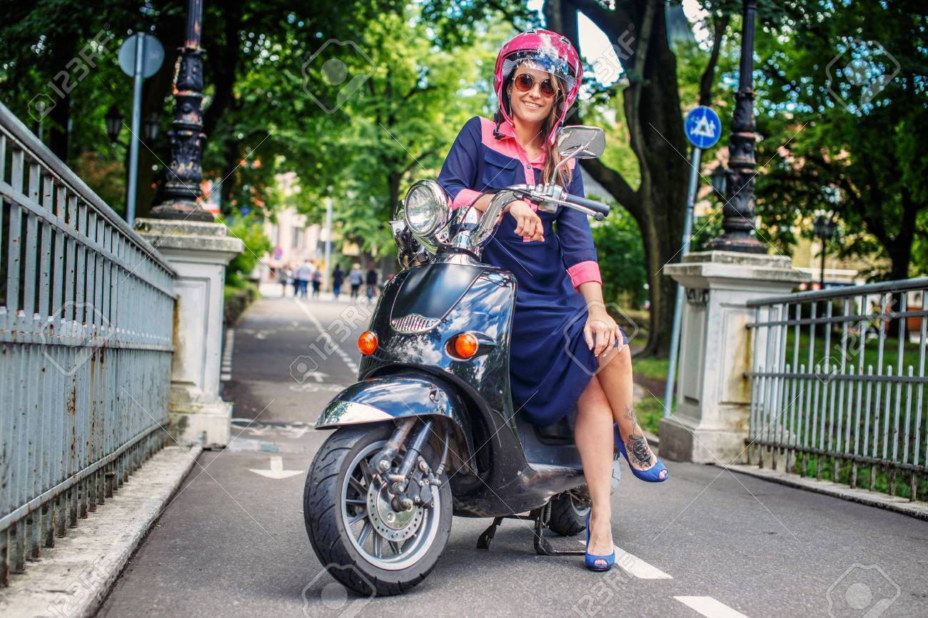 Fashin girl sitting on street scooter. - 44634620 Fashin girl sitting on street scooter. - 44634620