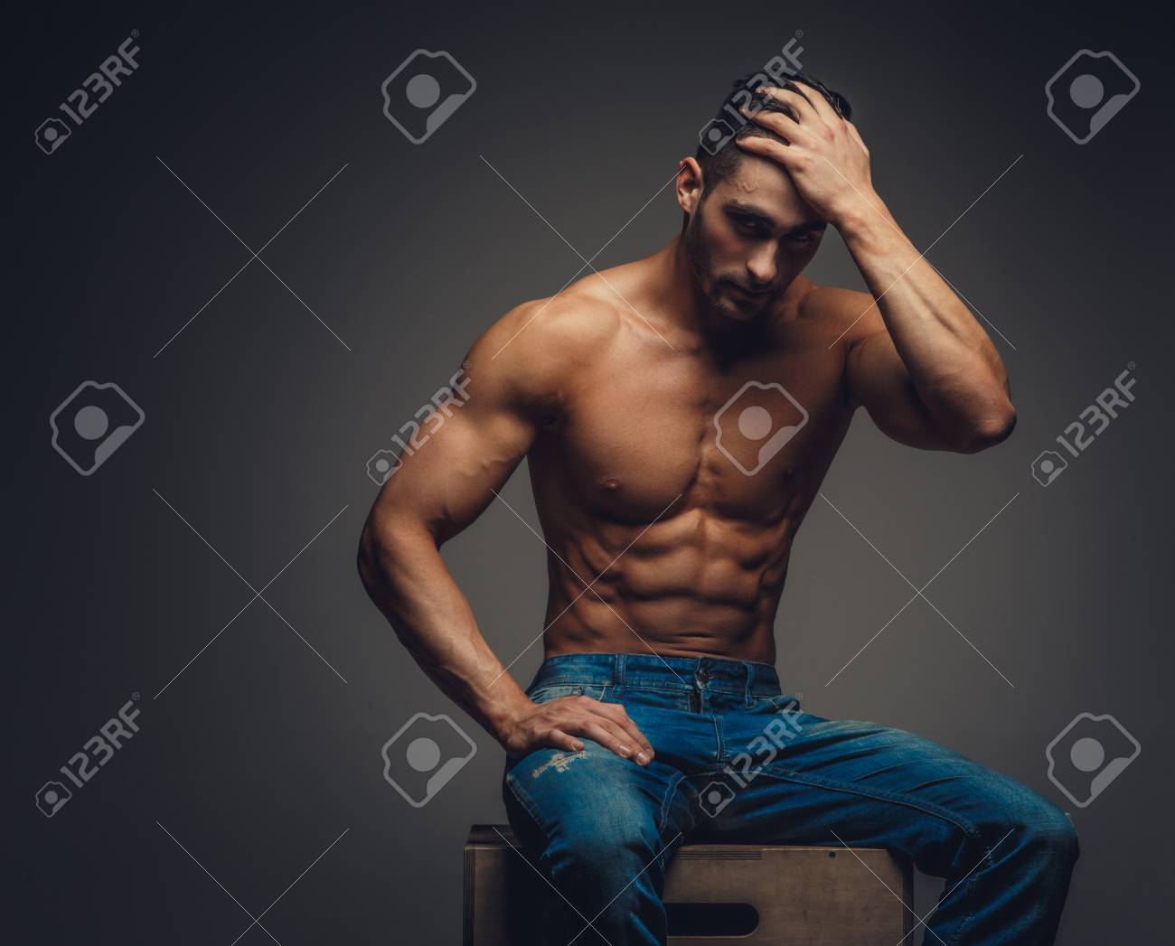 shirtless man in jeans