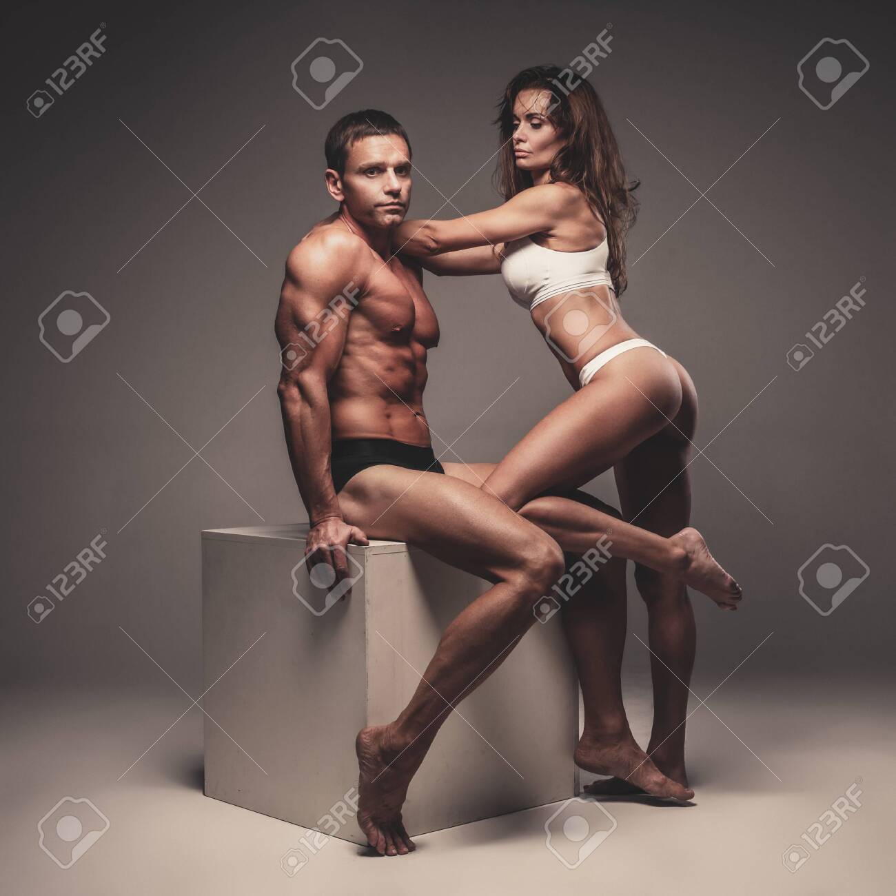 Naked Sexy Fitness Couple Posing In Studio Over Grey Background. Stock  Photo, Picture and Royalty Free Image. Image 124976076.
