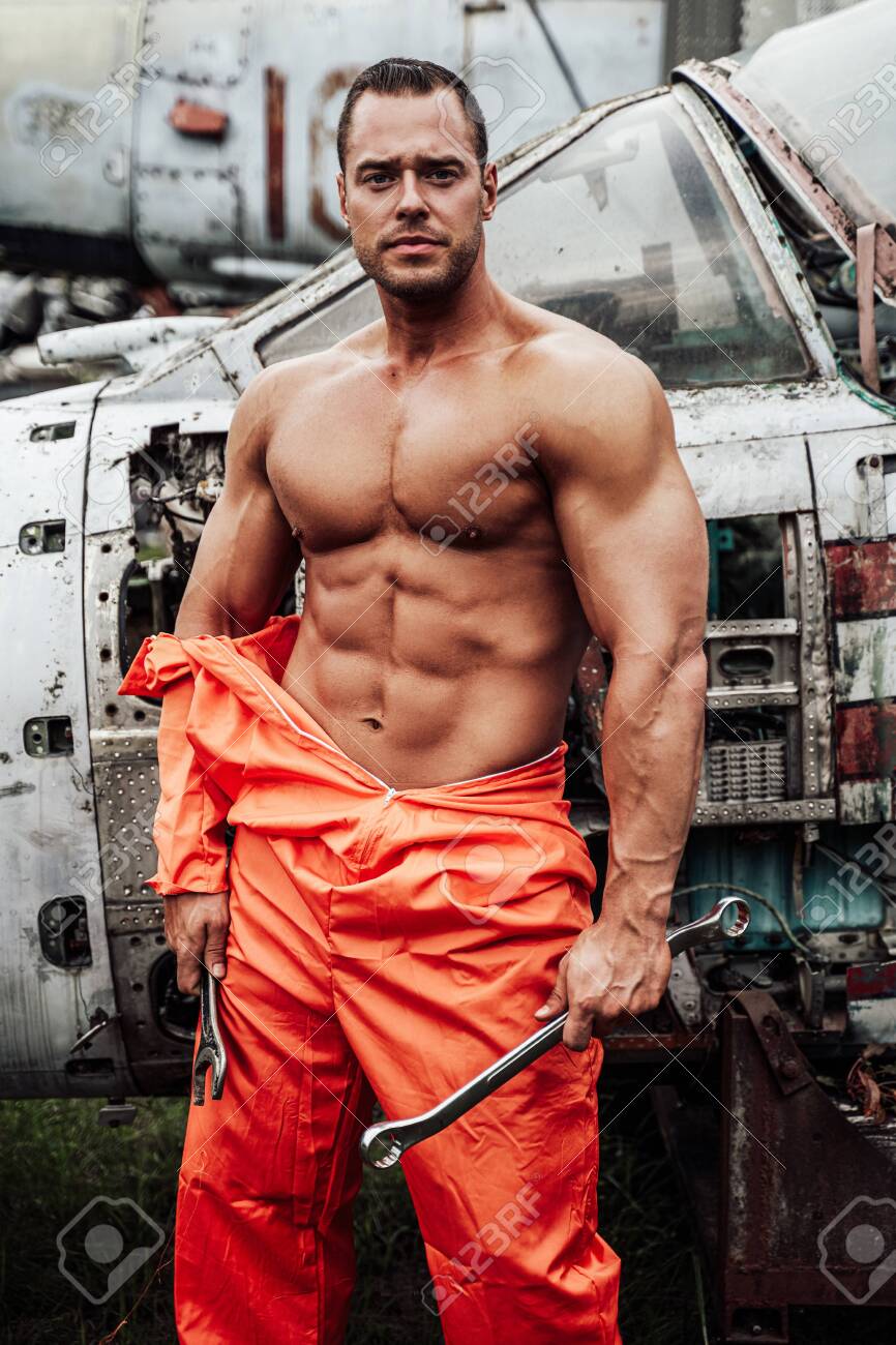 Escaped Prisoner Prepares To Repair Old Crashed Airplane. Muscular Guy In  Technician Prisoners Fashion. Stock Photo, Picture And Royalty Free Image.  Image 154852196.