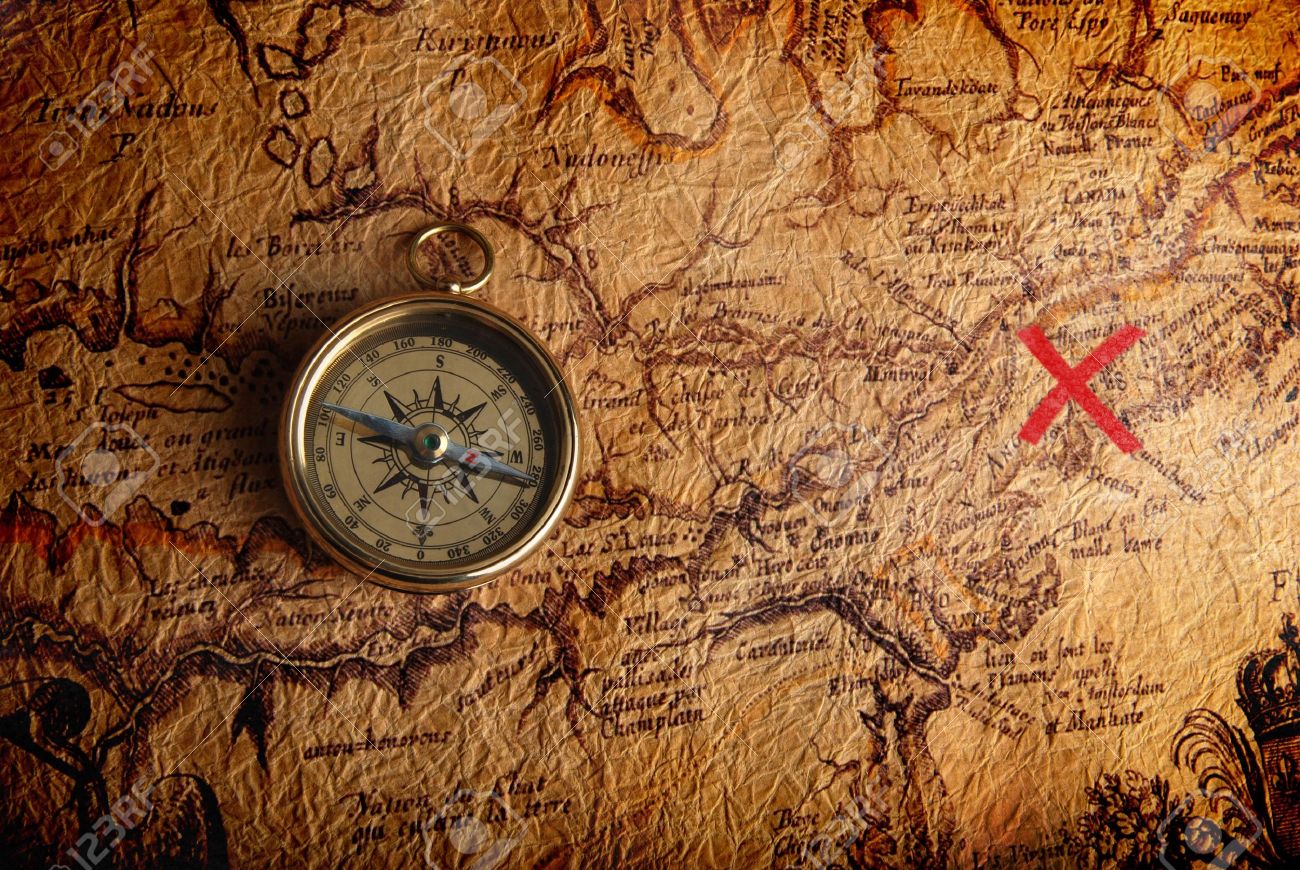 Old brass compass lying on a very old map showing the way to treasure - 6850429 Old brass compass lying on a very old map showing the way to treasure - 6850429