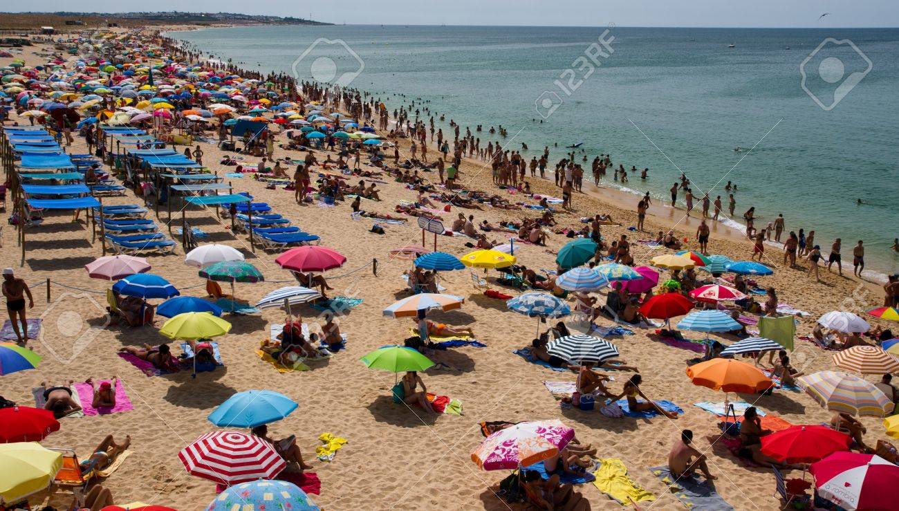 Crowded beach in summer on Algarve Coastline, Portugal - 21673907 Crowded beach in summer on Algarve Coastline, Portugal - 21673907