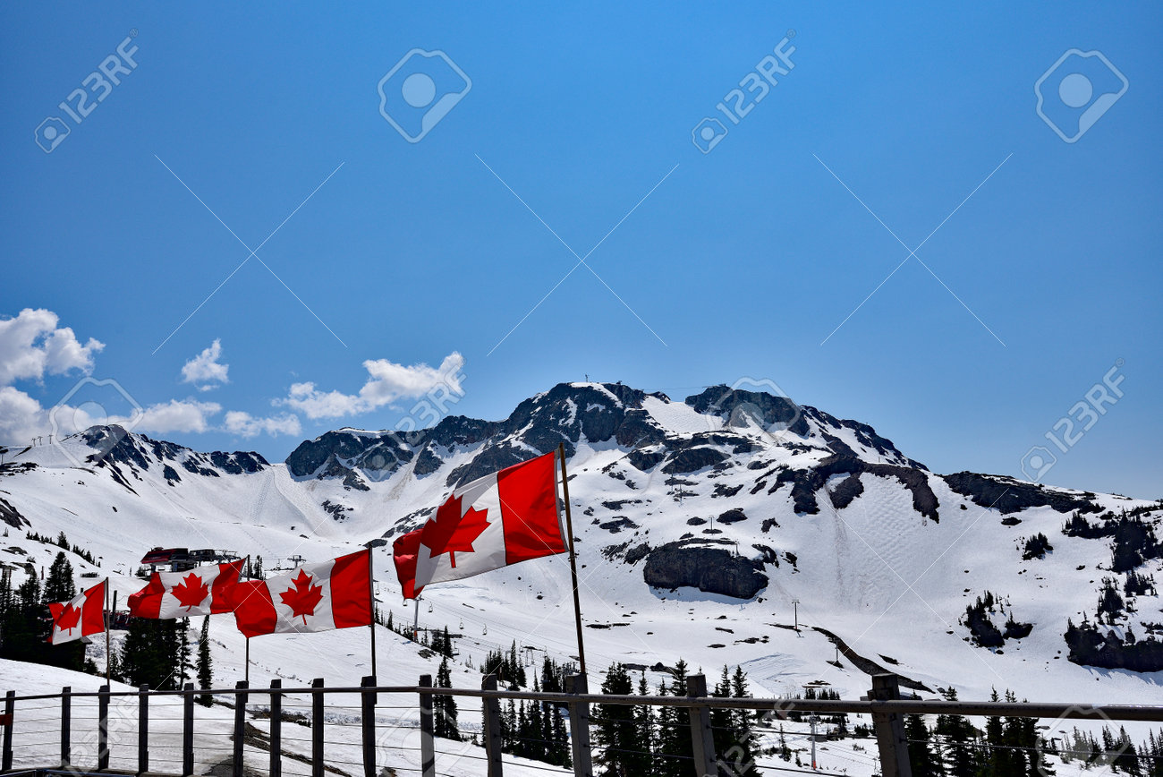 WHISTLER, BC, CANADA, MAY 30, 2019: The Canadian flags on the top of Blackcomb mountain in Whistler Village. Whistler is a canadian resort town visited by over 2 million people annually. - 160784260 WHISTLER, BC, CANADA, MAY 30, 2019: The Canadian flags on the top of Blackcomb mountain in Whistler Village. Whistler is a canadian resort town visited by over 2 million people annually. - 160784260