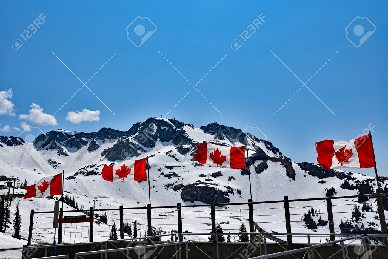 WHISTLER, BC, CANADA, MAY 30, 2019: The Canadian flags on the top of Blackcomb mountain in Whistler Village. Whistler is a canadian resort town visited by over 2 million people annually. - 160784251 WHISTLER, BC, CANADA, MAY 30, 2019: The Canadian flags on the top of Blackcomb mountain in Whistler Village. Whistler is a canadian resort town visited by over 2 million people annually. - 160784251