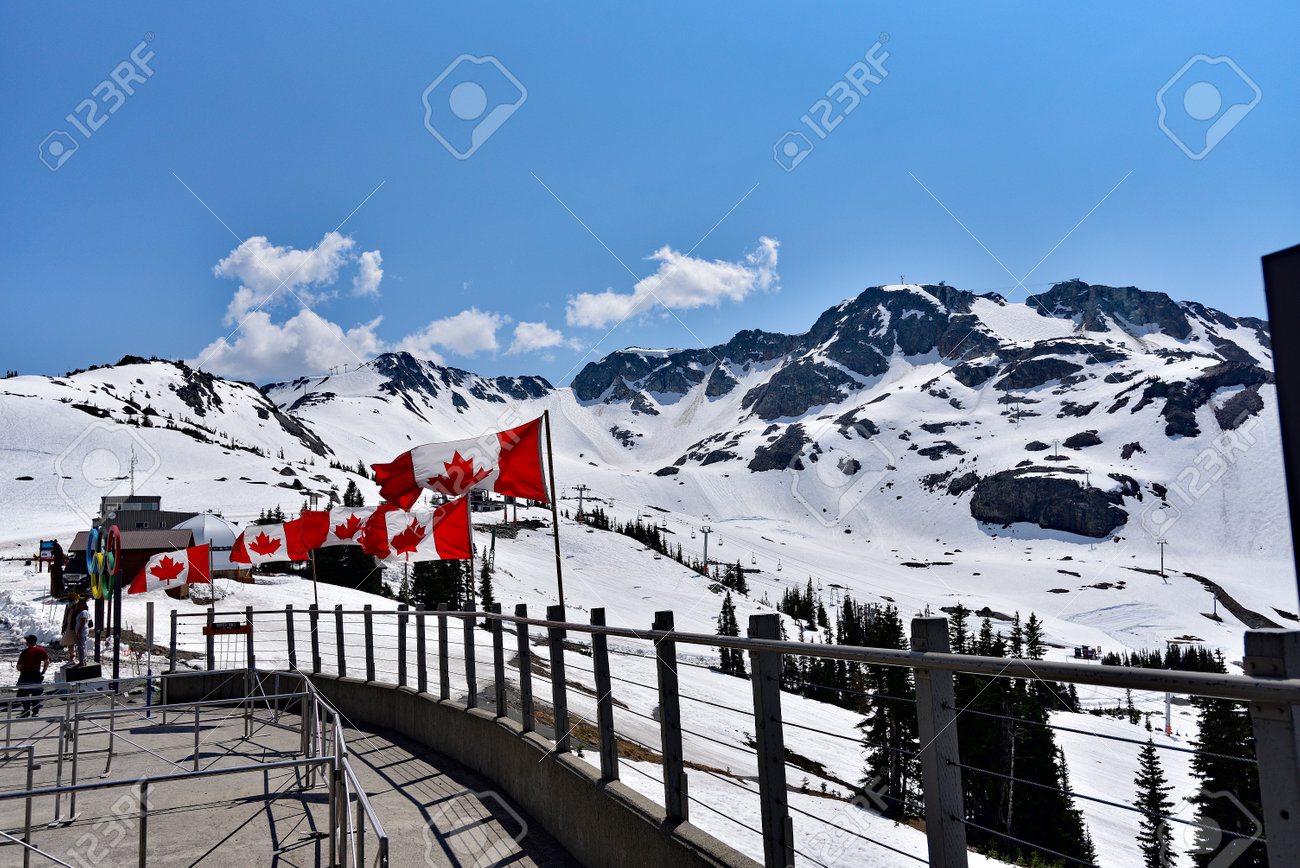 WHISTLER, BC, CANADA, MAY 30, 2019: The Canadian flags on the top of Blackcomb mountain in Whistler Village. Whistler is a canadian resort town visited by over 2 million people annually. - 160784266 WHISTLER, BC, CANADA, MAY 30, 2019: The Canadian flags on the top of Blackcomb mountain in Whistler Village. Whistler is a canadian resort town visited by over 2 million people annually. - 160784266