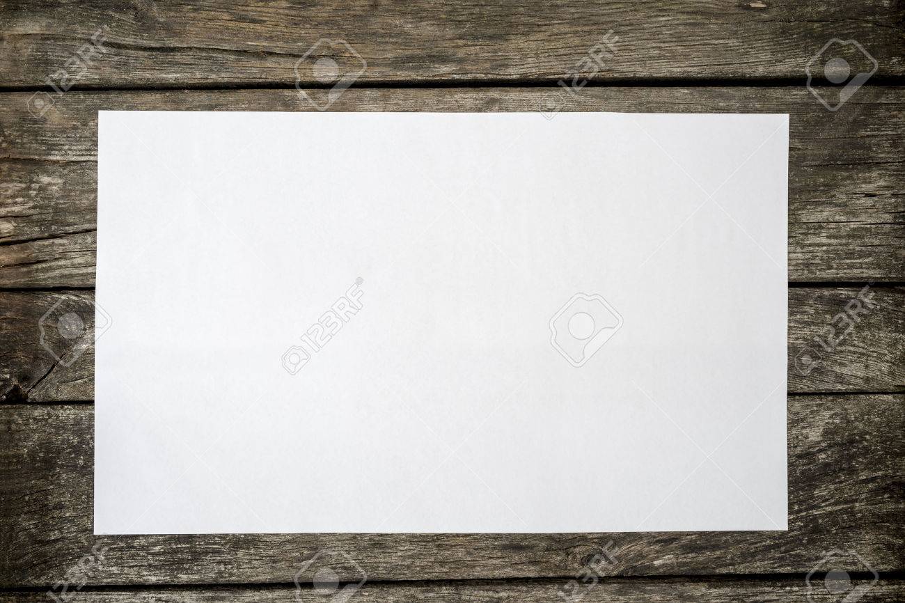 Top view of blank white piece of paper on a textured rustic wooden desk. - 54674763 Top view of blank white piece of paper on a textured rustic wooden desk. - 54674763