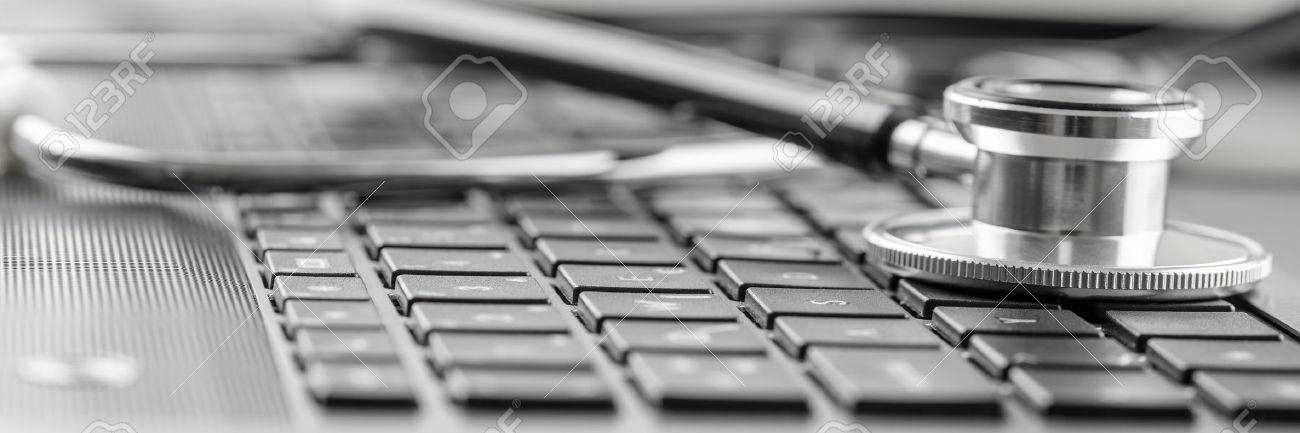 Panoramic image of the disc of a medical stethoscope lying on a computer keyboard in a concept of online medicine and healthcare. - 59362100 Panoramic image of the disc of a medical stethoscope lying on a computer keyboard in a concept of online medicine and healthcare. - 59362100