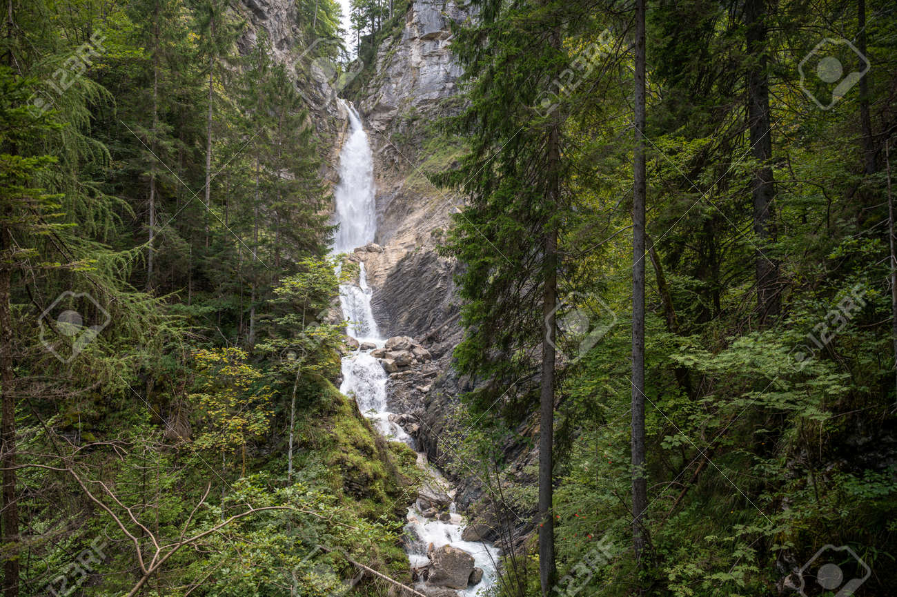Beautiful waterfall falling down the rocks in green summer forest. - 169239309 Beautiful waterfall falling down the rocks in green summer forest. - 169239309