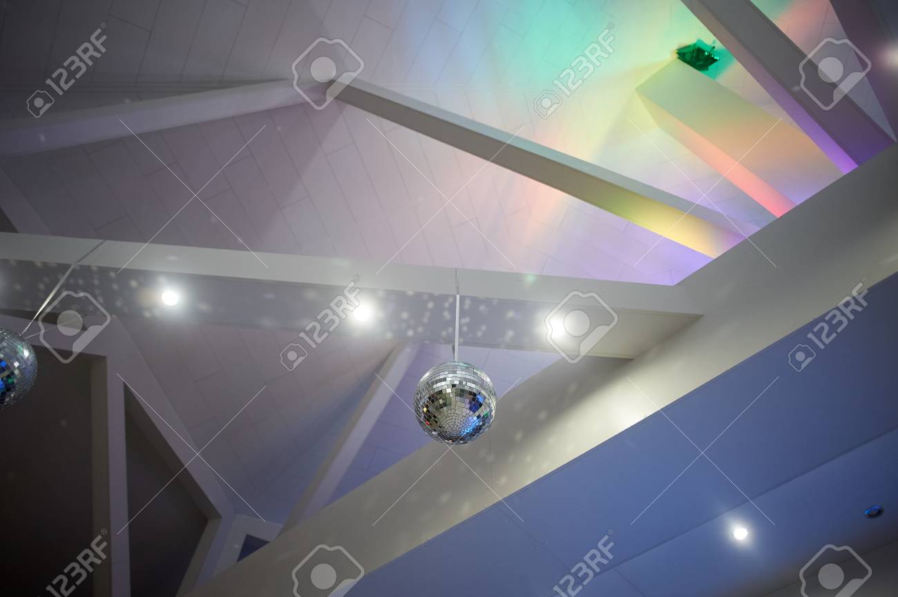 The High White Ceiling With Exposed Beams Decorated With Disco