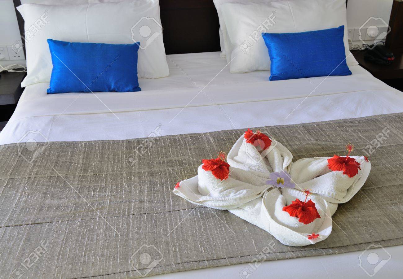 room in a hotel with a decoration of the towel and flowers on room in a hotel with a decoration of the towel and flowers on