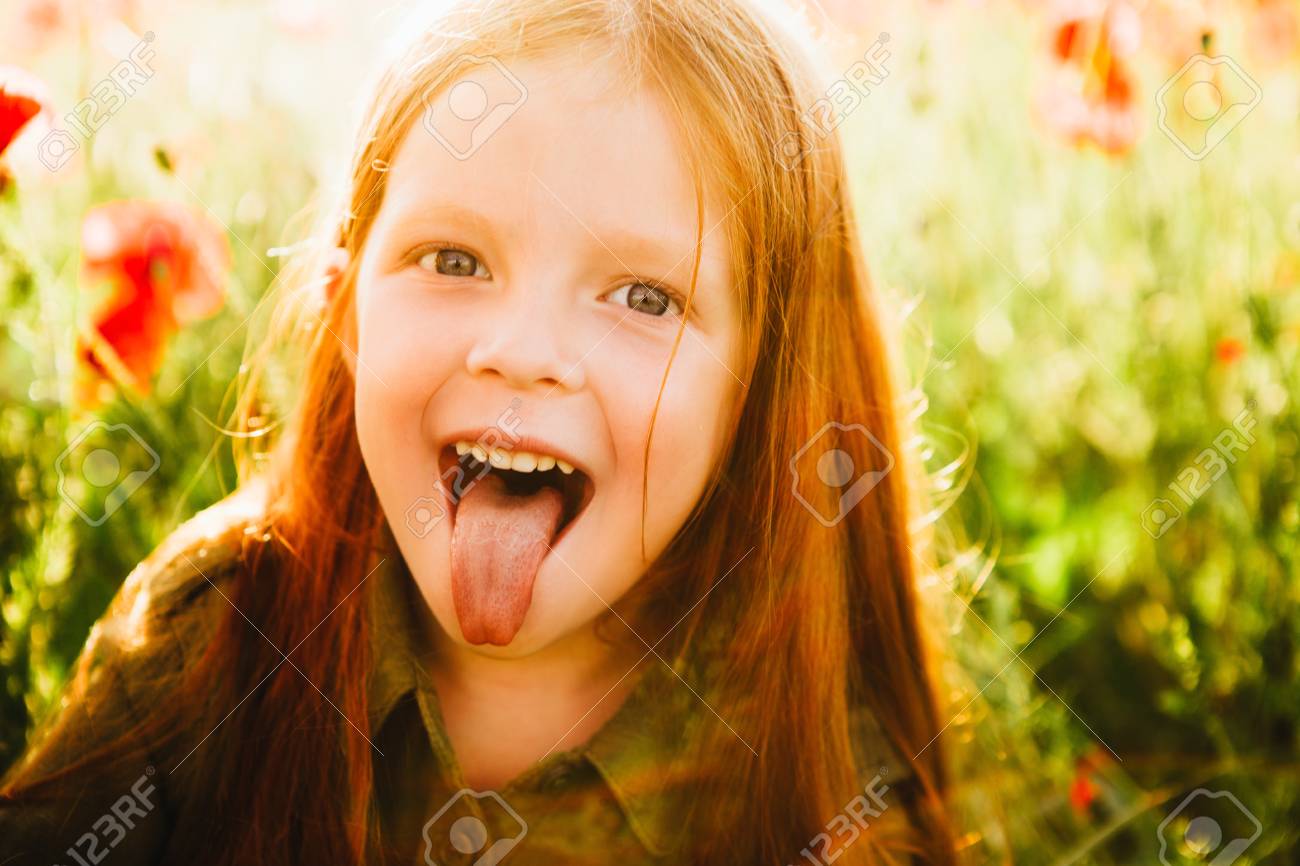 The Little Red-haired Girl Shows Tongue. Stock Photo, Picture and Royalty  Free Image. Image 103746218., image size:1300x866