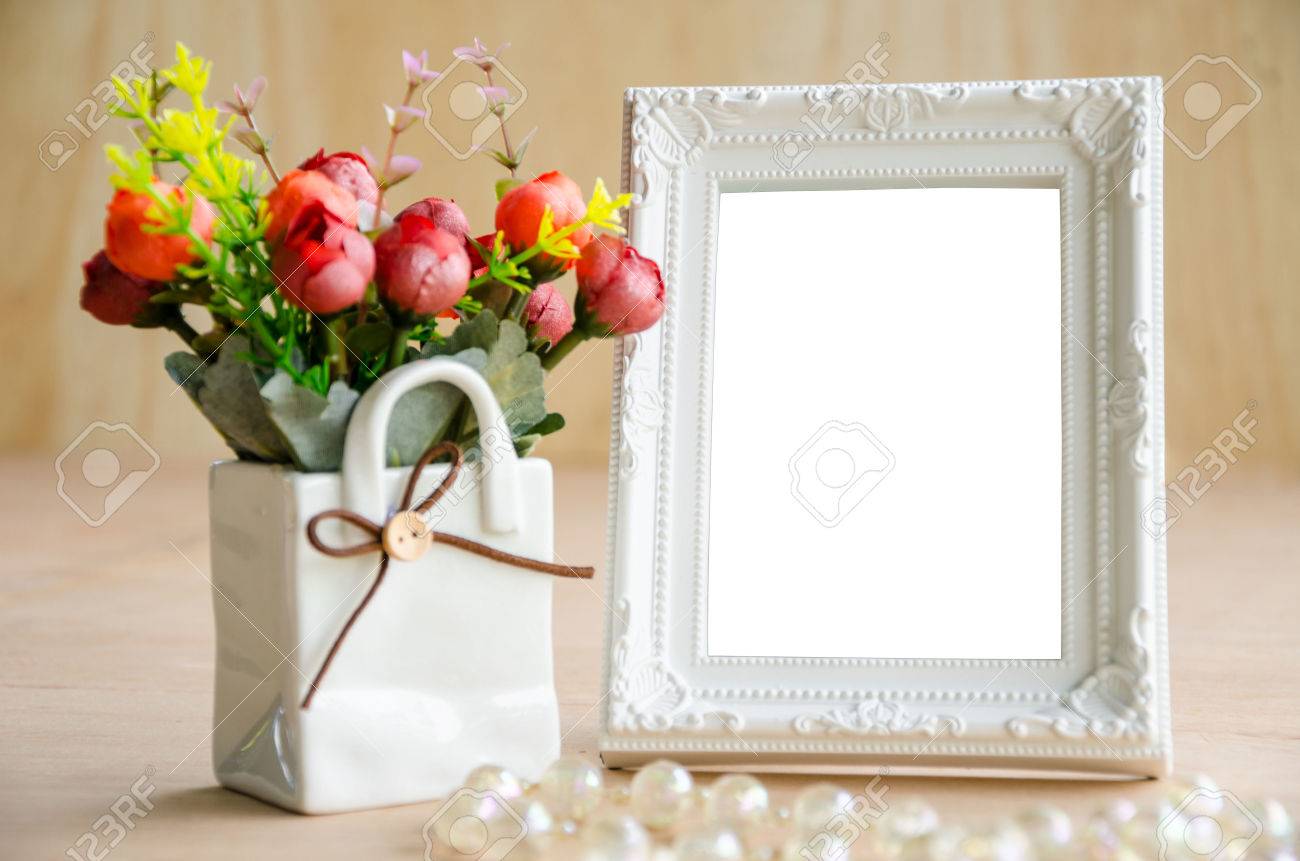 Flowers vase and vintage white picture frame on wooden desktop, clipping path - 42047455 Flowers vase and vintage white picture frame on wooden desktop, clipping path - 42047455