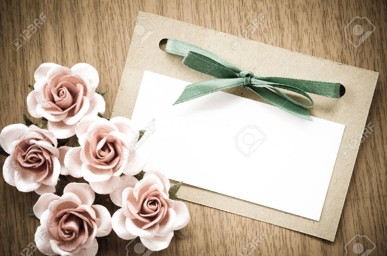 Vintage greeting card and rose flower on wooden background. - 42138194 Vintage greeting card and rose flower on wooden background. - 42138194