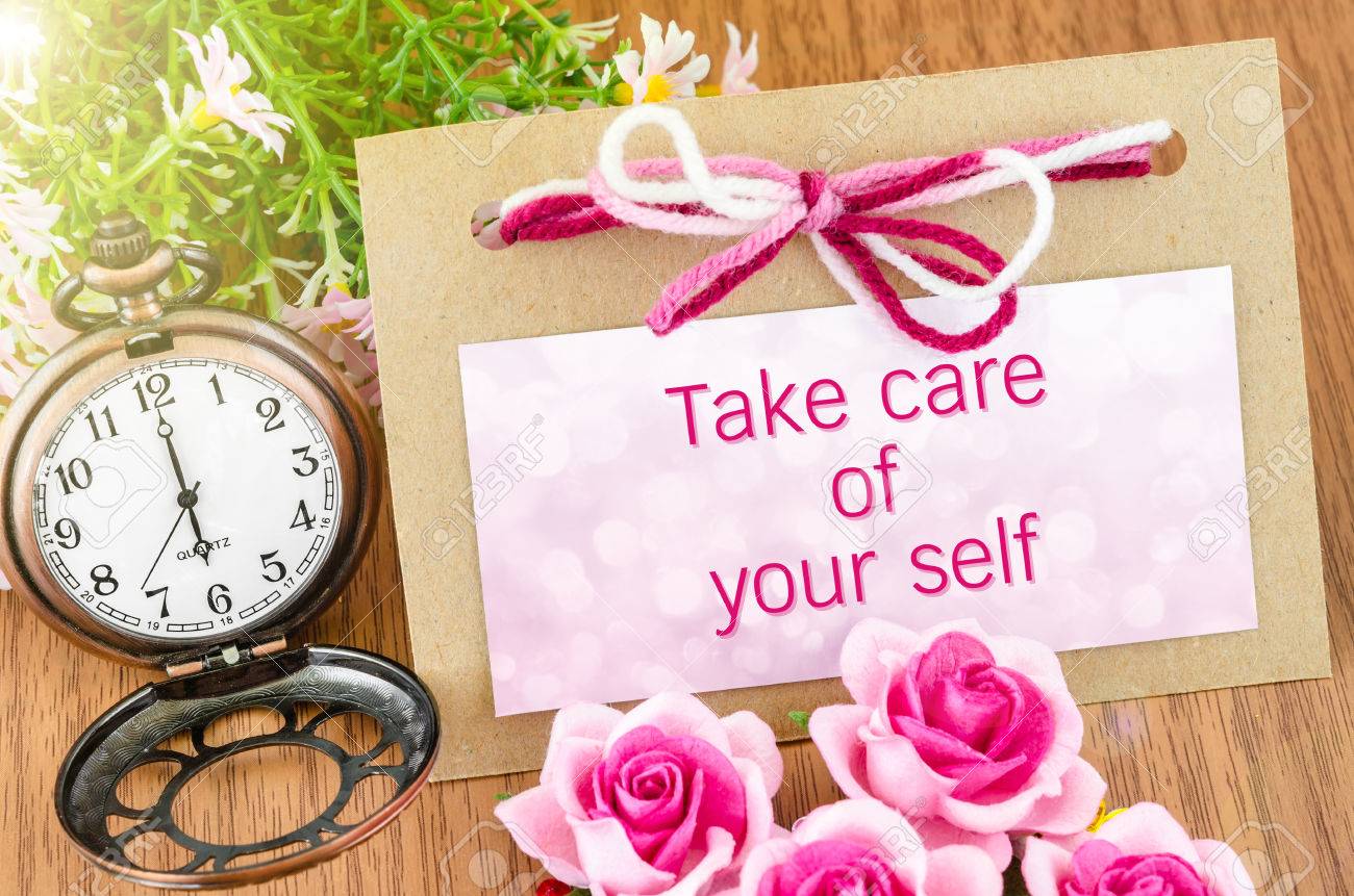 Take care of your self on tag and pocket watch with pink rose on wooden background. - 43296666 Take care of your self on tag and pocket watch with pink rose on wooden background. - 43296666