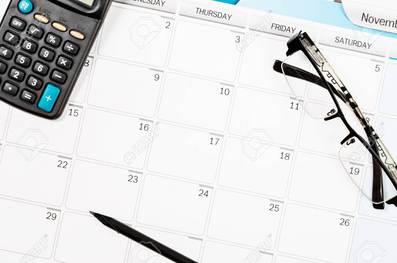 calendar schedule on work table and calculator pencil eye glasses schedule calculator