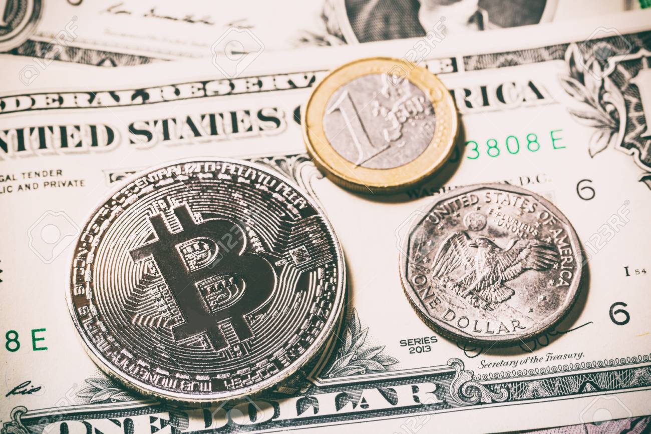 Cryptocurrency bitcoin coin cerca de una moneda de un dólar y una moneda de  euro en billetes de dólar. Símbolo de moneda criptográfica: dinero virtual  electrónico para banca web y pago de