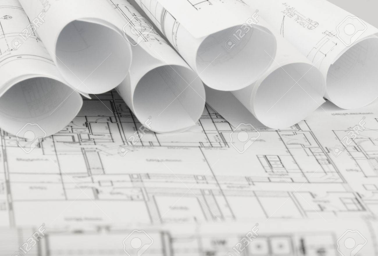 Architecture Blueprints rolls of architecture blueprints and house plans on the table Architecture Blueprints rolls of architecture blueprints and house plans on the table