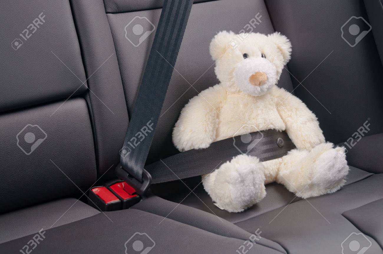 Teddy bear fastened in the back seat of a car, safety on the road - 47682160 Teddy bear fastened in the back seat of a car, safety on the road - 47682160