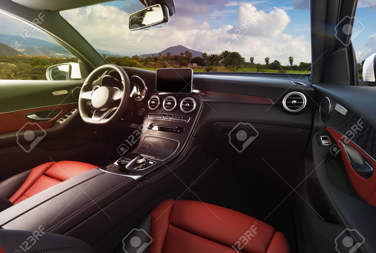 Modern luxury car Interior - steering wheel, shift lever and dashboard. Car interior luxury inside. Steering wheel, dashboard, speedometer, display. Red and black leather cockpit - 94293905 Modern luxury car Interior - steering wheel, shift lever and dashboard. Car interior luxury inside. Steering wheel, dashboard, speedometer, display. Red and black leather cockpit - 94293905