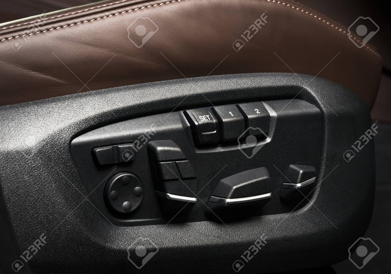 brown leather driver seat with stitching inside luxury car interior