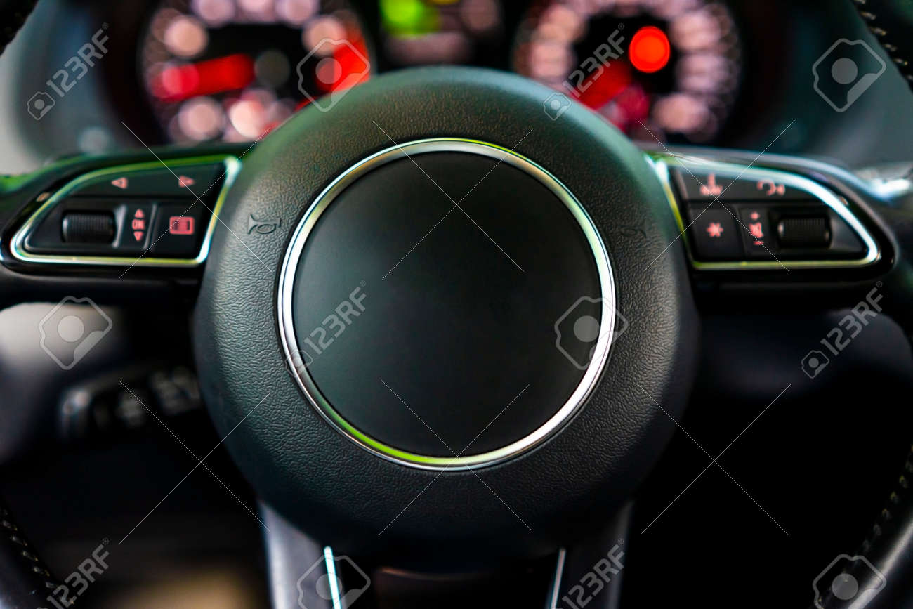 Modern luxury car Interior - steering wheel and blurred dashboard. Car interior luxury. Steering wheel, dashboard, speedometer, display. - 166244806 Modern luxury car Interior - steering wheel and blurred dashboard. Car interior luxury. Steering wheel, dashboard, speedometer, display. - 166244806