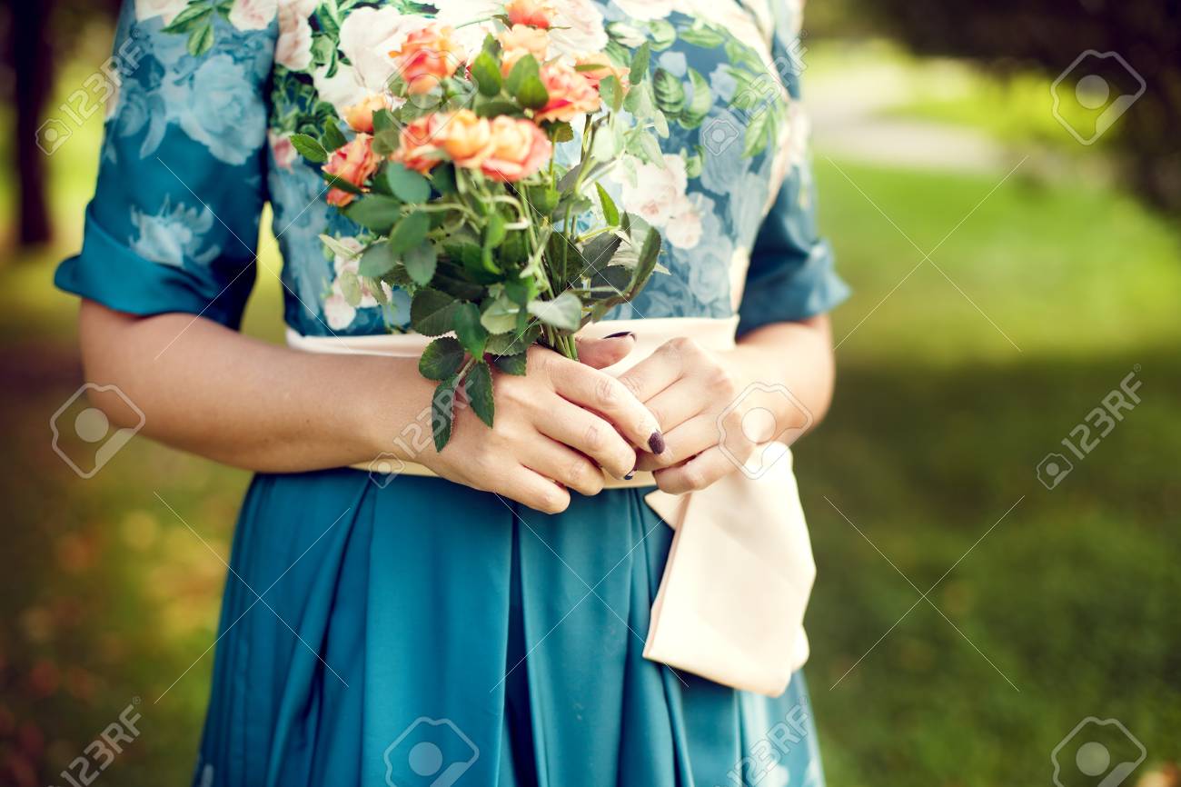 woman holding a bouquet of summer in the Park, floral dress, with a focus on flowers. Summer mood, holidays - 66915692 woman holding a bouquet of summer in the Park, floral dress, with a focus on flowers. Summer mood, holidays - 66915692