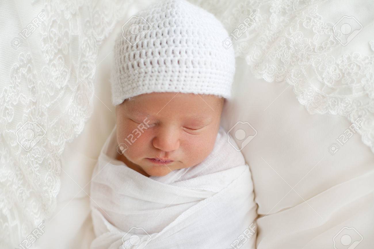 Newborn baby 7 days wrapped in white diaper and hat and sleeping peacefully in the cradle. Clean and disinfection, care of the child - 66916000 Newborn baby 7 days wrapped in white diaper and hat and sleeping peacefully in the cradle. Clean and disinfection, care of the child - 66916000